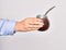 Hand of caucasian young woman holding mate infusion over isolated white background