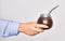 Hand of caucasian young woman holding mate infusion over isolated white background