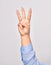 Hand of caucasian young woman showing number three with streched fingers raised up over isolated white background