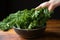 hand caught in the act of stealing a kale chip from a serving bowl