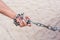 Hand with CHAIN metal and sand desert