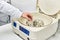 the hand of a chemical laboratory employee puts a blue drug into the experimental