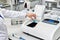 the hand of a chemical laboratory employee puts a blue drug into the experimental equipment