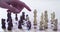 Hand, chess and checkmate with a person playing a strategy boardgame closeup in a home for leisure. Mind, brain and