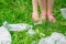 Hand of child cleans green grass from plastic trash