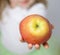 Hand of child holding ripe apple