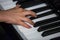 Hand of child playing piano close up