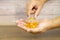 Hand choose a cod liver oil  capsule from a pile of cod liver oil or fish oil