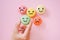 Hand choose emotion face on green macarons ,good feedback rating and positive customer review, experience, satisfaction survey ,