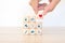 Hand chooses medical health care on cube wooden block stack pyramid concept of safety insurance for sick illness wellbeing