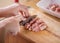 Hand chopping on beef in wooden cutting board