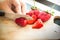 Hand chopping a fresh strawberry