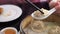 Hand chopsticks eating xiaolongbao soup dumpling in Chinese restaurant