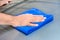 Hand cleaning car bonnet with microfiber cloth