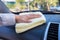 Hand cleaning car with microfiber cloth