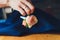 Hand clings to the bridegroom a boutonniere of real flowers.