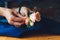 Hand clings to the bridegroom a boutonniere of real flowers.