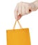 Hand close up with orange shopping bag isolated