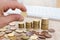 Hand with coin and money stacked