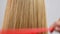 Hand is combing healthy long straight hair. Haircare. Beautiful and smooth blonde hair