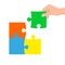Hand connecting jigsaw puzzle. Business concept. Symbol of teamwork, cooperation, partnership
