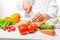 Hand cook cut vegetables for salad close up