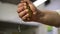 Hand cooks closeup squeezes lemon juice in the kitchen