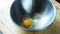 Hand cracking egg in a bowl