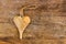 Hand crafted wooden heart with rope to hang on rough weathered w