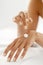 Hand Cream. Close Up Of Woman\'s Hands Applying Lotion On Skin