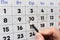 Hand cross out the last working day with a pencil in the calendar before the holiday