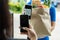Hand customer using digital mobile phone scan QR code paying for buying fresh food set bag from food delivery service man