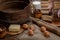 The hand cuts black bread on the background of ingredients for cooking bread