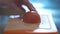 Hand cutting tomato in a kitchen