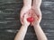 Hand dad and child heart red on black wooden