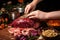 hand decorating beef roast with garlic cloves