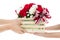 Hand delivers baskets of red and white rose flowers