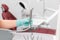 Hand of dentist in blue gloves holding ultrasonic teeth cleaning machine removing calculus and plaque. Oral hygiene and human