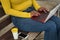 Hand detail african american woman in yellow t-shirt and jeans working her netbook