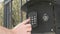 Hand dials number of apartment on intercom system