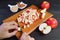 Hand dicing fresh apples on cutting board for making apple compote