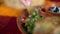 Hand dipping tortilla chip into plate of traditional pico de gallo