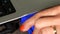 Hand disconnect vga display cord to laptop computer. Closeup