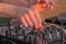 Hand of DJ controlling turntable console mixer. DJ playing music