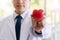 Hand of doctor holding red heart on nature background. medicine, profession and healthcare concept