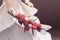 Hand of a doll bride holding a bouquet of flowers. Decorative we