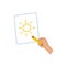 Hand drawing a picture of the sun on paper. Creating simple artwork with a pencil