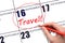 Hand drawing a red circle and writing the text TRAVEL on the calendar date 16 September . Travel planning.