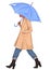 Hand drawn fashion sketch girl with umbrella. Woman wearing coat and steps on a white background. Deep blue jeans, blue umbrella