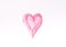 Hand drawn shape of the heart. Sample of pink lip gloss on a white background